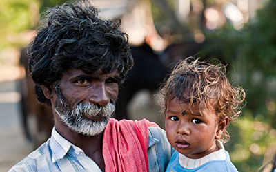 A man holds his baby daughter in India.