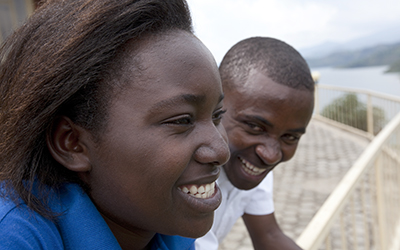 A man and woman, smiling in conversation.