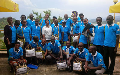 A group of men and women at the launch of Pillars of Peace in Rwanda smile for the camera.