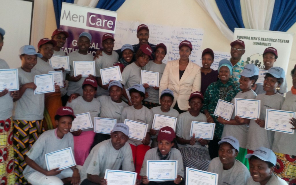 Health providers hold up their certificates after completing training with MenCare+ Rwanda (Bandebereho) in a group photo.