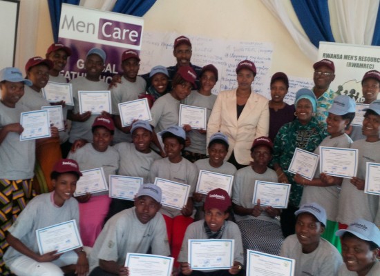 Health providers hold up their certificates after completing training with MenCare+ Rwanda (Bandebereho) in a group photo.