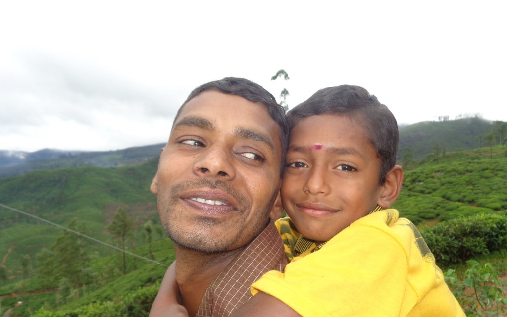 A close-up of a man giving his son a piggy back ride in Sri Lanka.