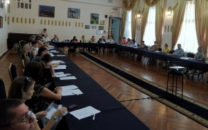 Attendees at the International Conference on Family and Child Integration in St. Petersburg, Russia sit around a large conference table.