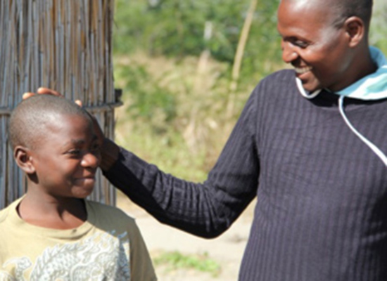 A father and son smile at each other