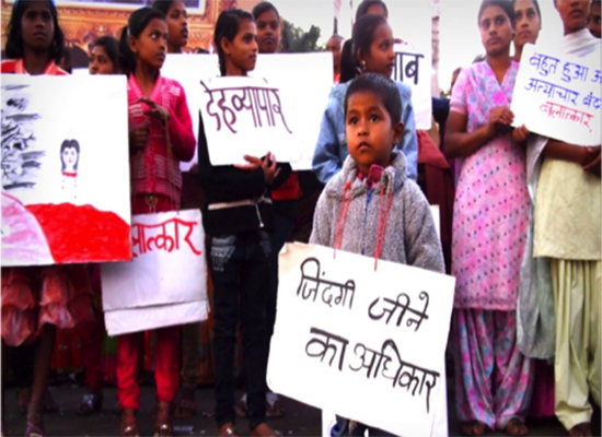 Village members hold up signs promoting the Fathers Care campaign in India