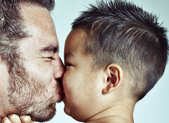 A father kisses his son. © Marilyn Nieves/iStockphoto.com