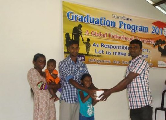 A family receives a graduation certificate at MenCare Sri Lanka's June 2015 family retreat.