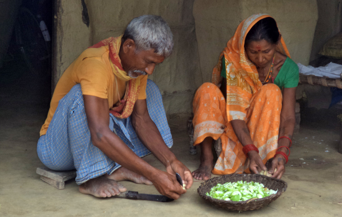 A grandfather participates in the preparation of food. Credit: SSDO, Nepal, 2015.