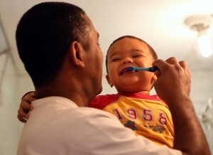 Marcio brushes his young son's teeth in a still from "MenCare Short: Brazil."