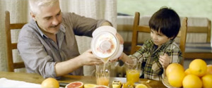 Father and child make orange juice together in still from MenCare Bulgaria's film "To Be A Dad."