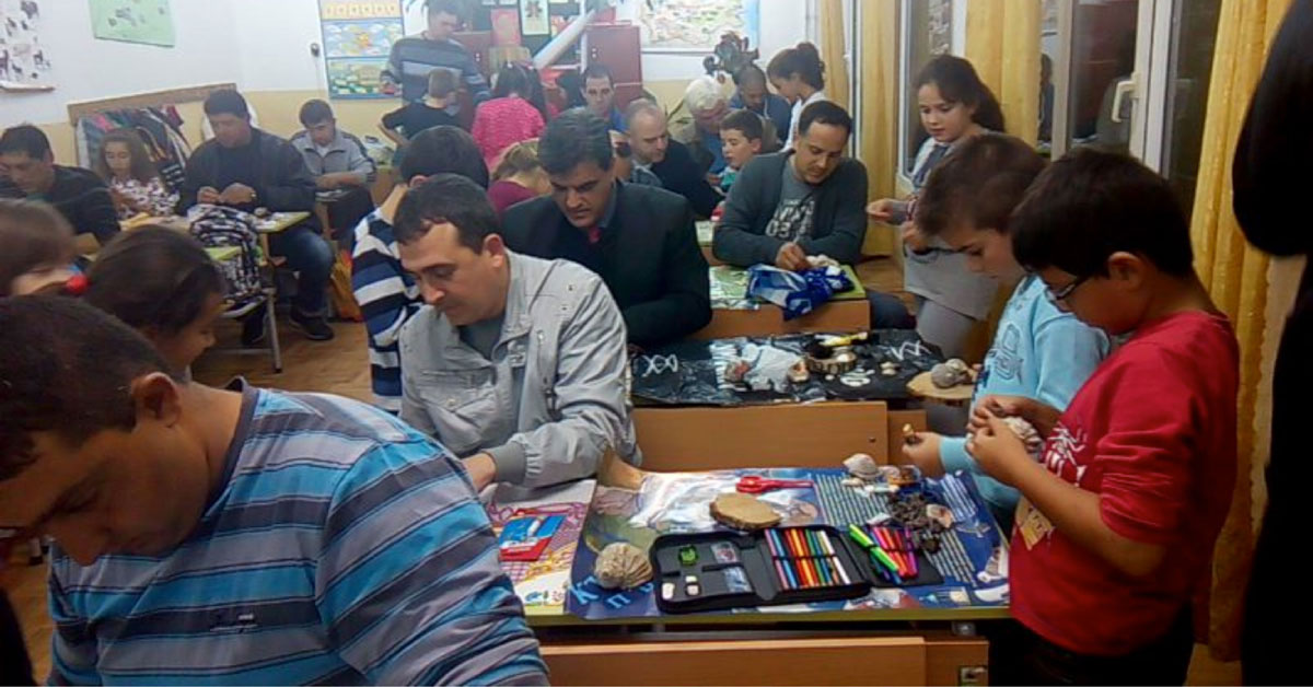 Fathers and children participate in a workshop with seashells in a school in Tsarevo, Bulgaria.