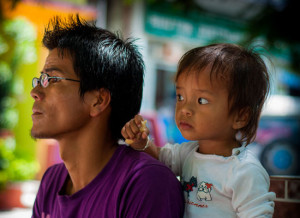 A father and child look into the distance.