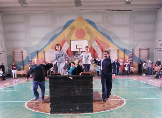 Fathers and children in a gymnasium.