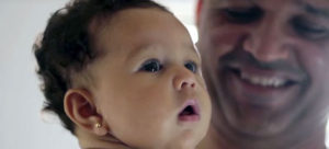 Close-up of a baby and smiling father.