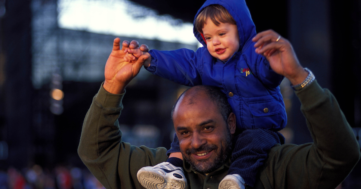 Father with child on his shoulders.