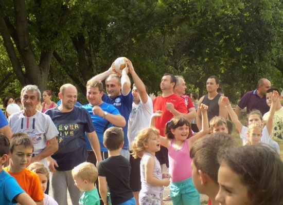 Fathers and children play outside.